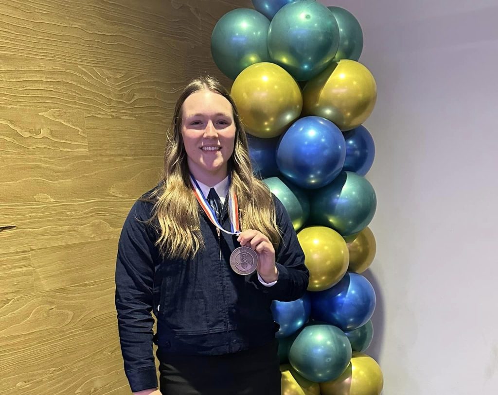 Arallai Wartick holding her medal.